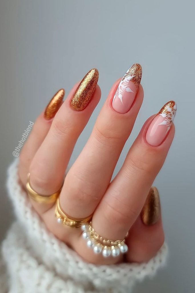 nude nails with texture of golden glitter and snow design 